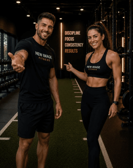 Two fitness trainers smiling in a gym.